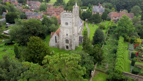 Aerial-Reveal-Of-Old-Church-Behind-Tree-In-Parish-Village-In-Kent