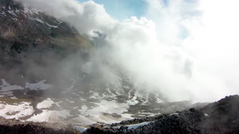 FPV-aerial-drone-flying-over-mountain-top-and-through-cloud-for-view-of-Aletsch-Glacier-in-the-Swiss-Alps