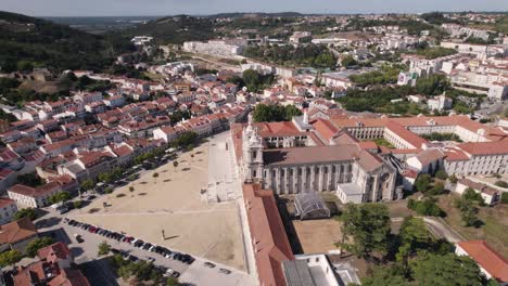 Profile-view-of-historic-landmark-Alcobaça-monastery-complex-against-cityscape,-Portugal
