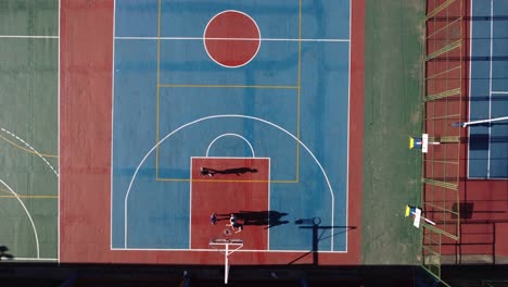 Aerial-top-down-view-directly-above-amateur-basketball-court-with-players