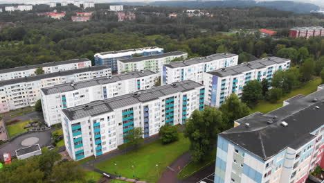 Modern-apartment-buildings-with-green-energy-rooftops-in-Sweden,-aerial-drone-view