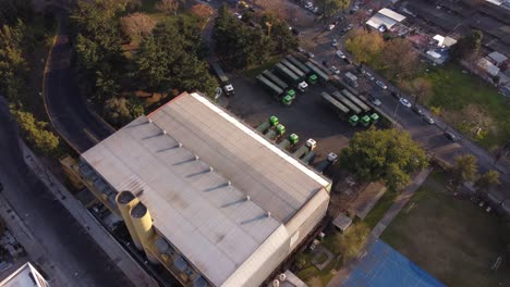 Drone-tilt-down-shot-of-parking-trucks-on-waste-to-energy-factory-in-district-of-Buenos-Aires,Argentina---Environmental-treatment-and-recycling-of-sewage