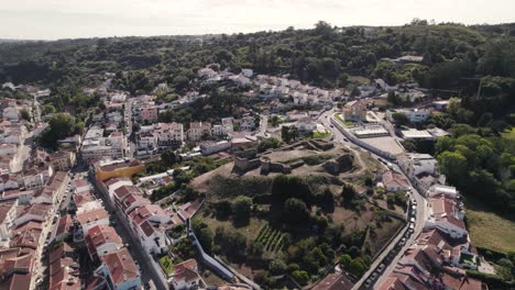 Aerial-pan-shot-capturing-the-historic-remains-of-Castillo-de-Alcobaça-from-above,-Portugal