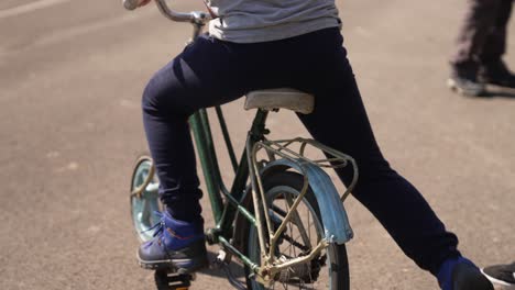Close-up-of-child-jumping-on-the-little-bike---Concept-of-learn-to-ride-a-bicycle