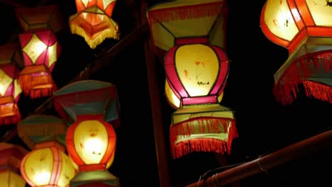 Chinese-lantern-lights-hang-as-the-camera-quickly-passes-by-against-a-night-sky
