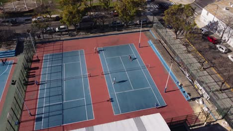 Aerial-shot-showing-tennis-players-at-court-playing-doubles-game-outdoors-in-Buenos-Aires