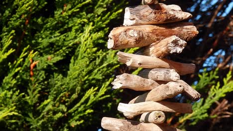 Hand-made-Viking-hanging-driftwood-Valhalla-ladder-garland-decoration-in-sunny-garden-close-up
