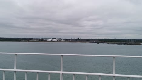 A-sideways-moving-shot-of-southampton-from-the-channel-ferry-to-east-cowes-on-a-very-grey-and-overcast-day-in-england,-this-video-was-shot-on-the-sony-A7sii-mirrorless-camera