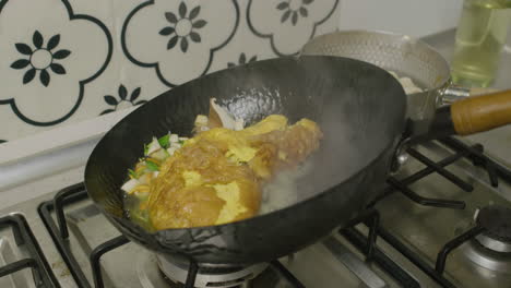 Adding-water-into-the-abalone-and-egg-dish-inside-big-Asian-frying-pan