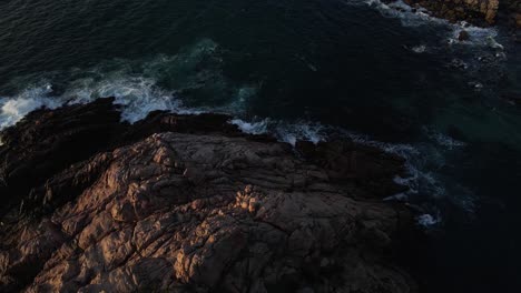Aerial-flight-along-the-coast-of-Western-Australia-with-waves-crashing-on-the-shore-during-sunset