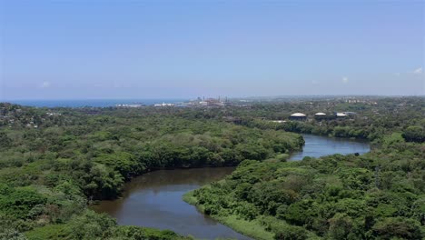 Backwards-flying-over-the-banks-of-the-Haina-River,-in-the-vicinity-of-the-Engombe-Mill-Ruin