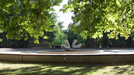 Revealing-from-trees-shot-of-doves-fountain---Landmark-in-Sad-Janka-Krala,-Bratislava,-capital-of-Slovakia---summer-sunny-day
