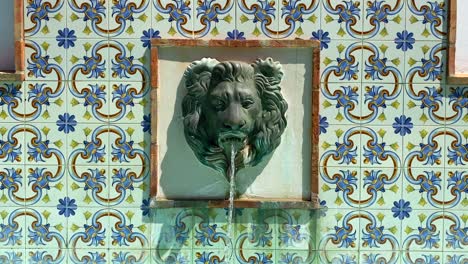 Lion-head-water-fountain-with-beautiful-tiles-in-a-typical-Spanish-city-Estepona