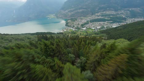 Aerial-flight-downhill-the-green-mountains-towards-tourist-town-Odda-and-Fjord-in-Norway---FPV-Dynamic-drone-shot