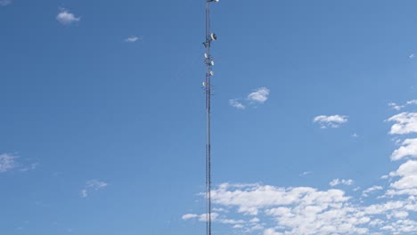 Time-lapse-shot-of-5g-6g-transmission-antenna-tower-against-moving-clouds-and-blue-sky