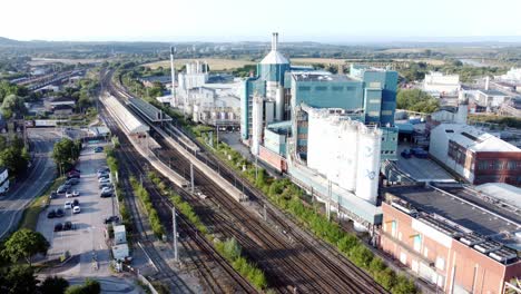 Industrial-chemical-manufacturing-factory-next-to-Warrington-Bank-Quay-train-tracks-aerial-view-reversing-slowly