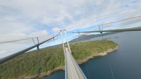 Aerial-flight-over-Bømla-Suspension-Bridge-with-driving-car-in-Norway