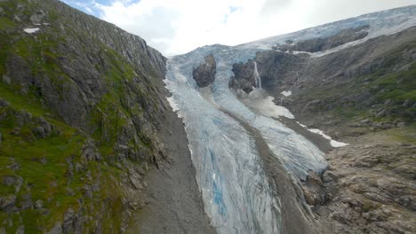 Aerial-view-on-mountain-top-showing-melting-glacier-ice-after-heat-in-summer