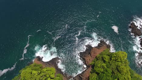 Overhead-Hover-of-Rugged-Jungle-Island-Point-with-Crashing-Waves-on-Rocks