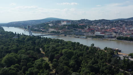Wide-aerial-revealing-shot-of-Green-park-and-Bratislava,-capital-of-Slovakia---summer-sunny-day