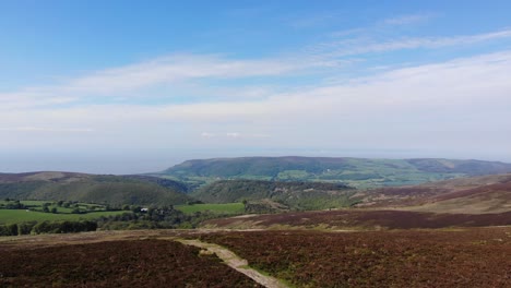 Aerial-Over-Top-Of-Dunkery-Beacon-Covered-In-Heather-Moorland