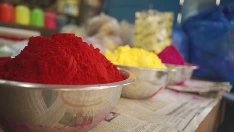 Color-powders-or-gulal-on-bowl-or-container-for-sell-on-shop,-Holi,-Indian-festival-of-colors