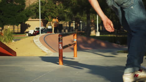 Skateboarder-hops-and-slides-along-a-rail-at-a-skate-park