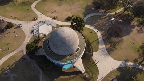 Aerial-over-the-dome-of-Galileo-Galilei-planetarium,-Parque-Tres-de-Febrero,-Buenos-Aires,-Argentina