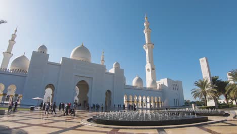 Outer-entrance-of-Sheikh-Zayed-Grand-Mosque,-Abu-Dhabi,-United-Arab-Emirates,-handheld-pan-shot