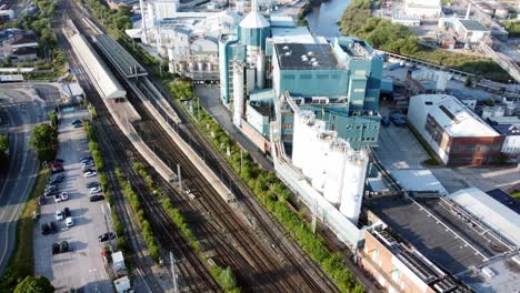 Industrial-chemical-manufacturing-factory-next-to-Warrington-Bank-Quay-train-tracks-aerial-view-top-down-tilt-up