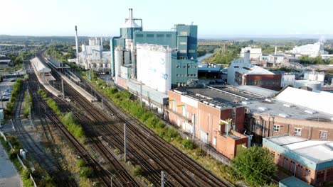 Industrial-chemical-manufacturing-factory-next-to-Warrington-Bank-Quay-train-tracks-aerial-view-low-to-high