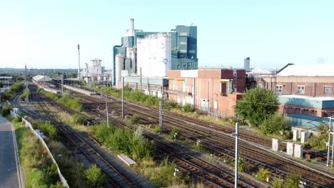 Industrial-chemical-manufacturing-factory-next-to-Warrington-Bank-Quay-train-tracks-rising-aerial-view