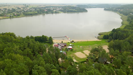 Ruhige-Landschaft-Mit-üppiger-Grüner-Vegetation-Und-Malerischem-See-In-Hartowiec,-Polen---Luftdrohnenaufnahme