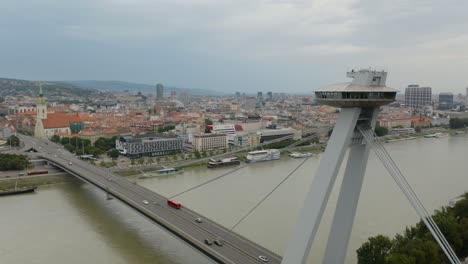 Fixed-Aerial-View-of-Most-SNP-UFO-Bridge,-Bratislava,-Slovakia-in-Background