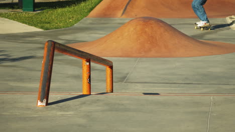 Skateboarder-grinding-a-rail-at-a-skate-park