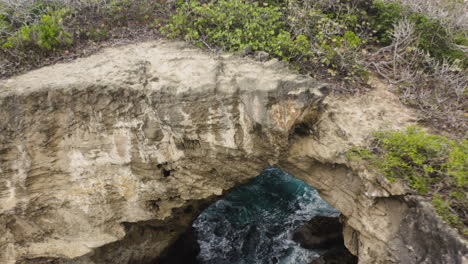 Rocky-Cliffs-And-Caves-At-Cueva-del-Indio-In-Las-Piedras,-Puerto-Rico---aerial-drone-shot