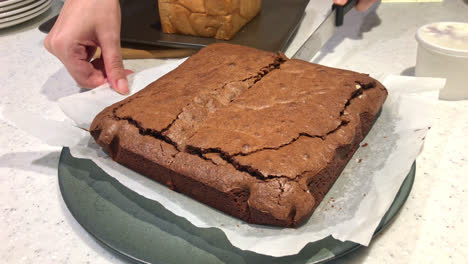 cutting-chocolate-brownies-cake-board