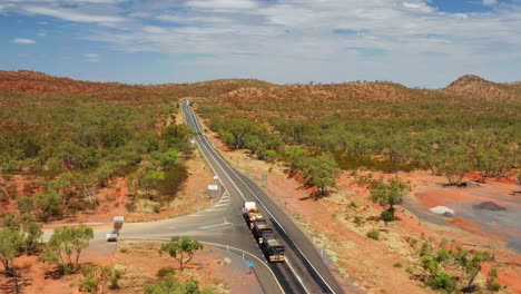 Three-trailer-Road-Train-In-The-Australian-Outback-Road-On-A-Sunny-Day-In-QLD,-Australia