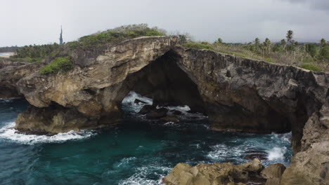 Cueva-Del-Indio-En-Las-Piedras,-Puerto-Rico-Con-Olas-Rompiendo-En-Los-Acantilados---Toma-Aérea-De-Drones