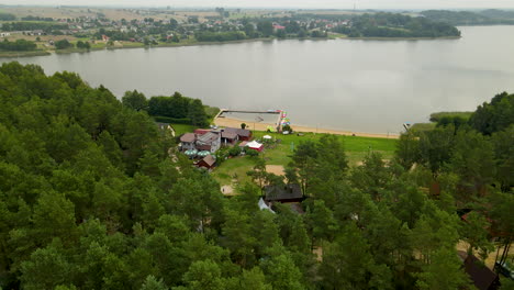 Aerial-shot-of-rural-landscape-with-natural-sandy-beach-and-nature-lake-reservoir-in-background
