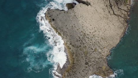 Bird's-Eye-View-Of-Turquoise-Ocean-And-Cliffs-At-Cueva-del-Indio,-Las-Piedras,-Puerto-Rico---aerial-drone-shot