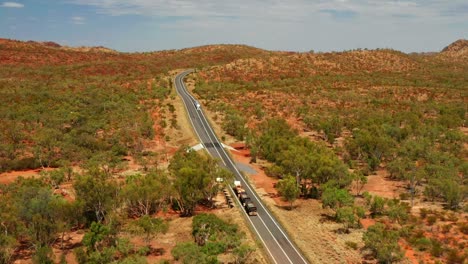 Aerial-View-Of-Three-trailer-Road-Train-Travelling-In-Outback-Asphalt-Road-In-QLD,-Australia