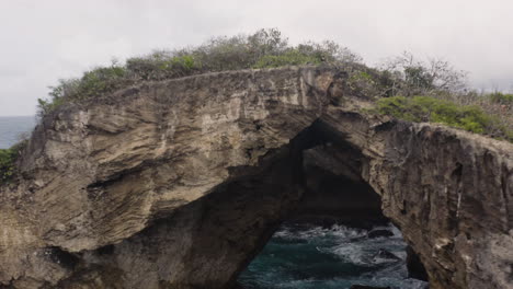 Ancient-Natural-Cavern-By-The-Sea,-El-Indio-Cave-In-Las-Piedras,-Puerto-Rico---aerial-drone-shot