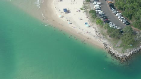 Aerial-view-of-busy-Noosa-Main-Beach,-Noosa-Heads,-Queensland,-Australia