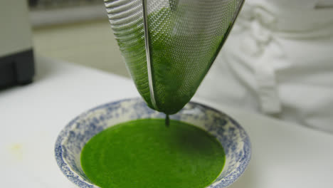Straining-spinach-leaves-for-juice-puree-extraction