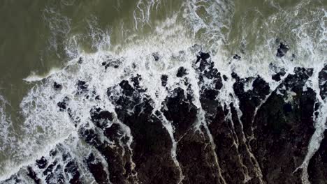 Top-Down-Aerial-View-Of-Waves-Crashing-Along-Kingsgate-Coastline
