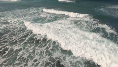 Tranquil-ocean-wave-coming-towards,-Indian-Ocean,-pedestal-drone-shot