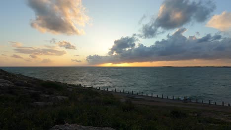 Zeitraffer-Sonnenuntergang-Wolkengebilde-über-Meer-Mit-Fließendem-Wasser,-Statische-Ansicht