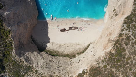 Remains-Of-MV-Panagiotis-Shipwreck-In-Navagio-Beach-With-Vacationists-During-Summer-In-Greece