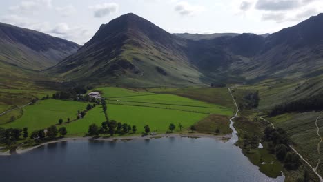 Buttermere-Lake-District-UK-aerial-footage-of-stunning-landscape-calm-day,-summer,-Fleetwood-pike-fell-in-background